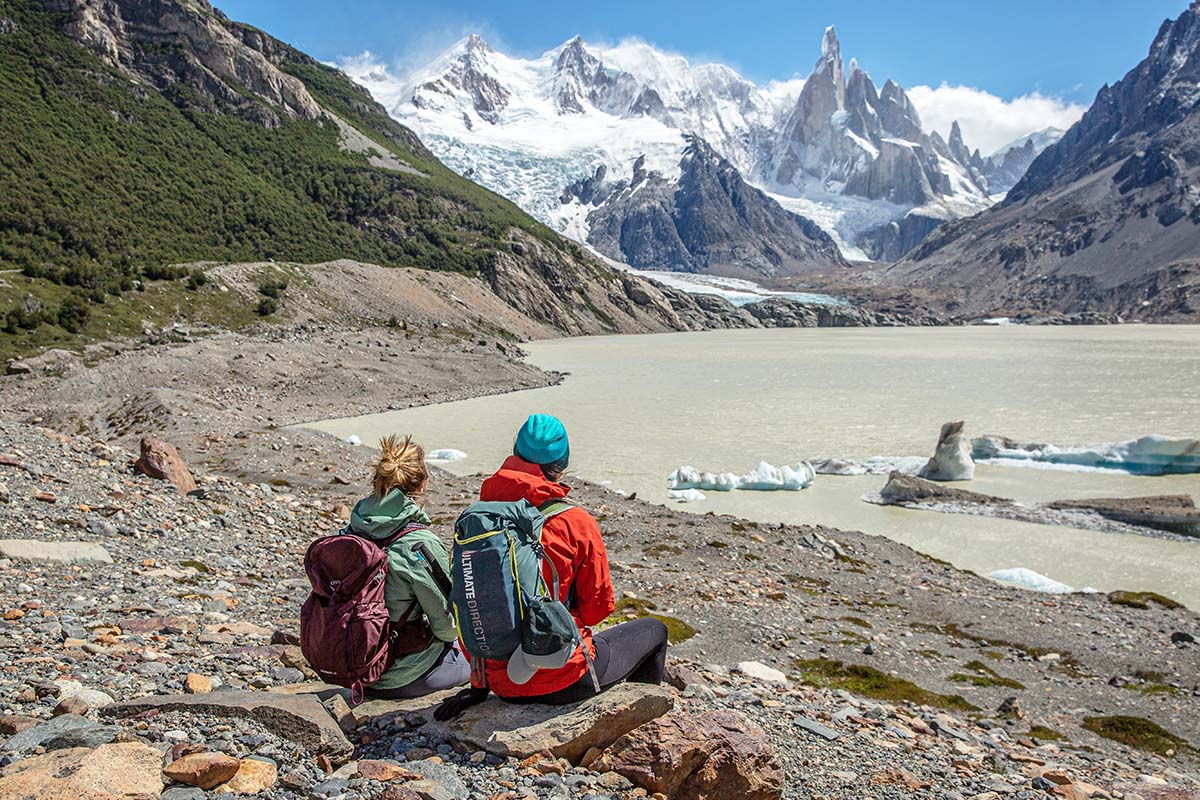 Two women looking at Cerro Torre from across Laguna Torre